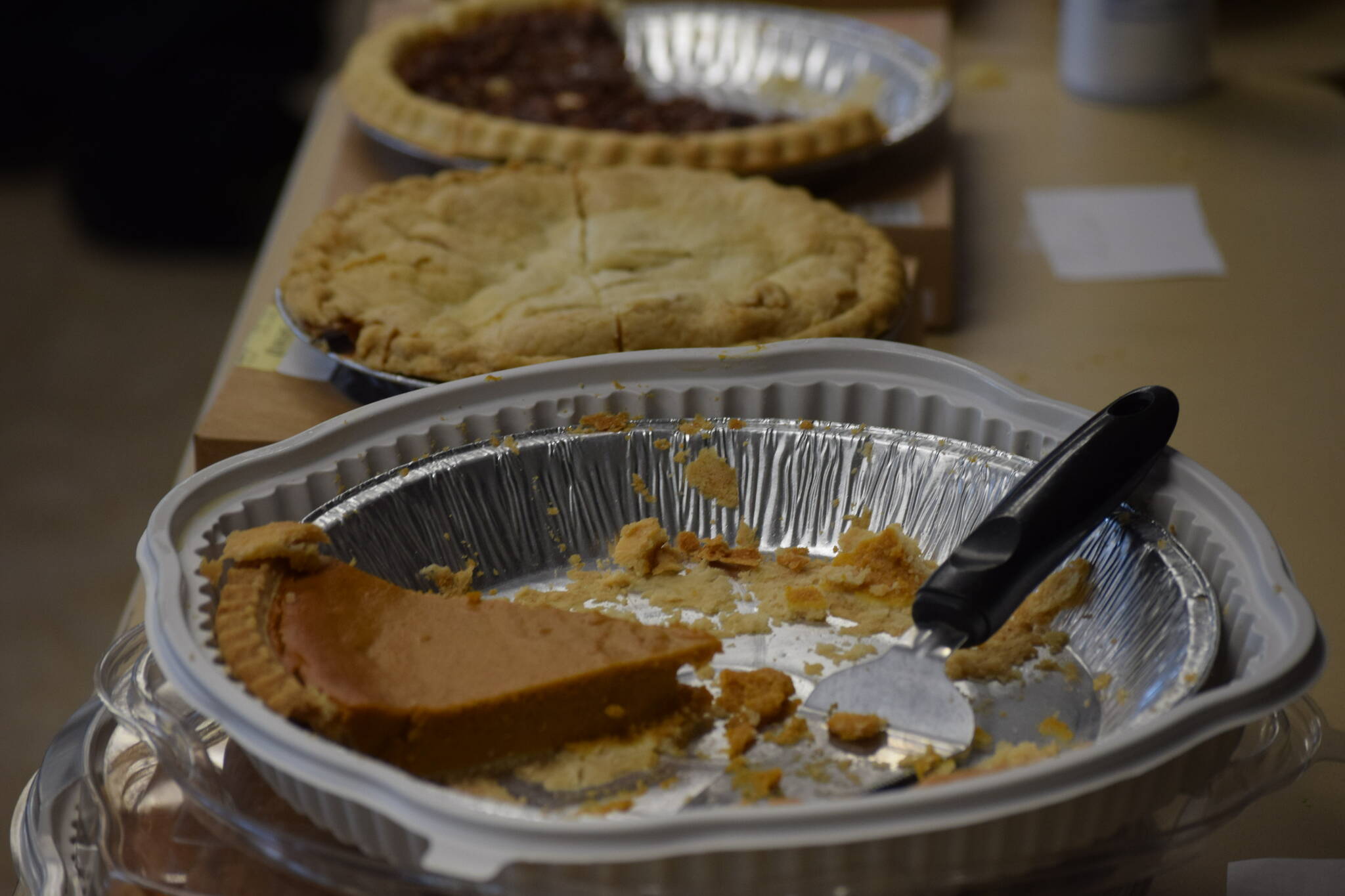 Pie slowly disappears during the Thanksgiving lunch at the Kenai Peninsula Food Bank on Wednesday, Nov. 24, 2021. (Camille Botello/Peninsula Clarion)