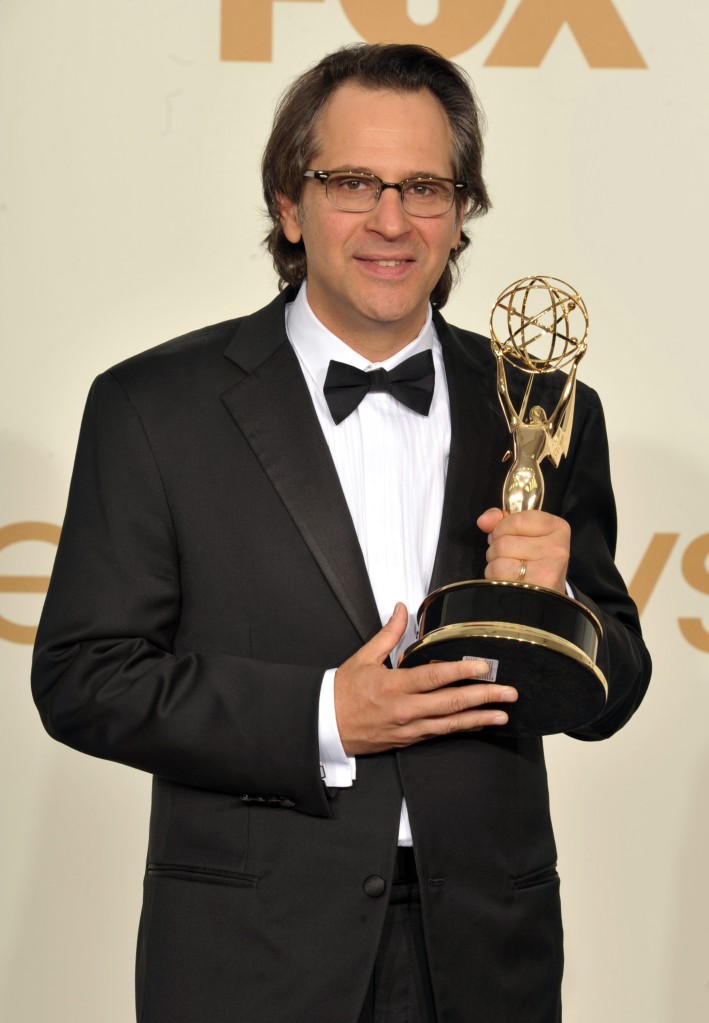 Jasom Katims holds an Emmy 