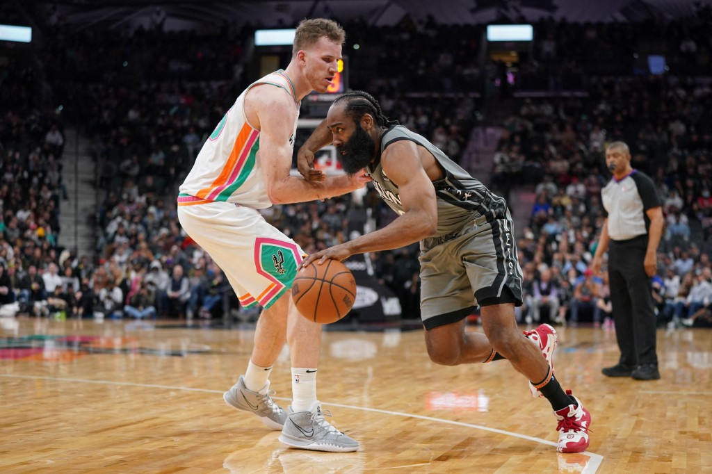 James Harden drives past Jakob Poeltl during the Nets' win over the Spurs.