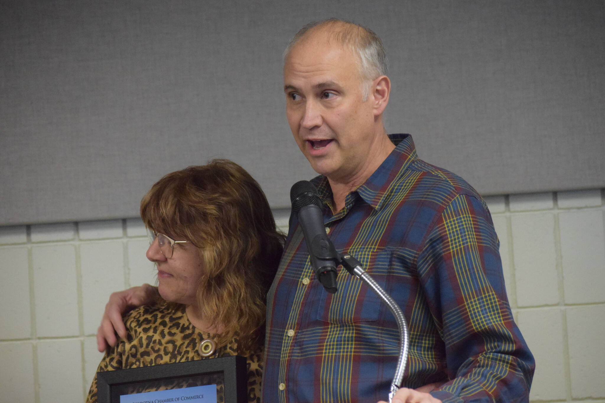 Mary Krull, with husband Henry Krull, accept the Soldotna Chamber of Commerces business of the year award for their work at Brew 602 and Addie Camp during the chambers 2021 award ceremony at the Soldotna Regional Sports Complex on Wednesday, Feb. 9, 2022. (Camille Botello/Peninsula Clarion)