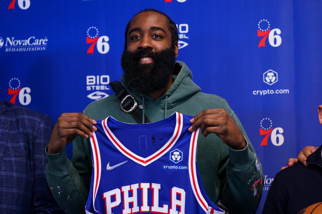 Philadelphia 76ers' James Harden holds up his new jersey after taking questions from the media at a press conference at the team's facility, Tuesday, Feb. 15, 2022, in Camden, N.J.